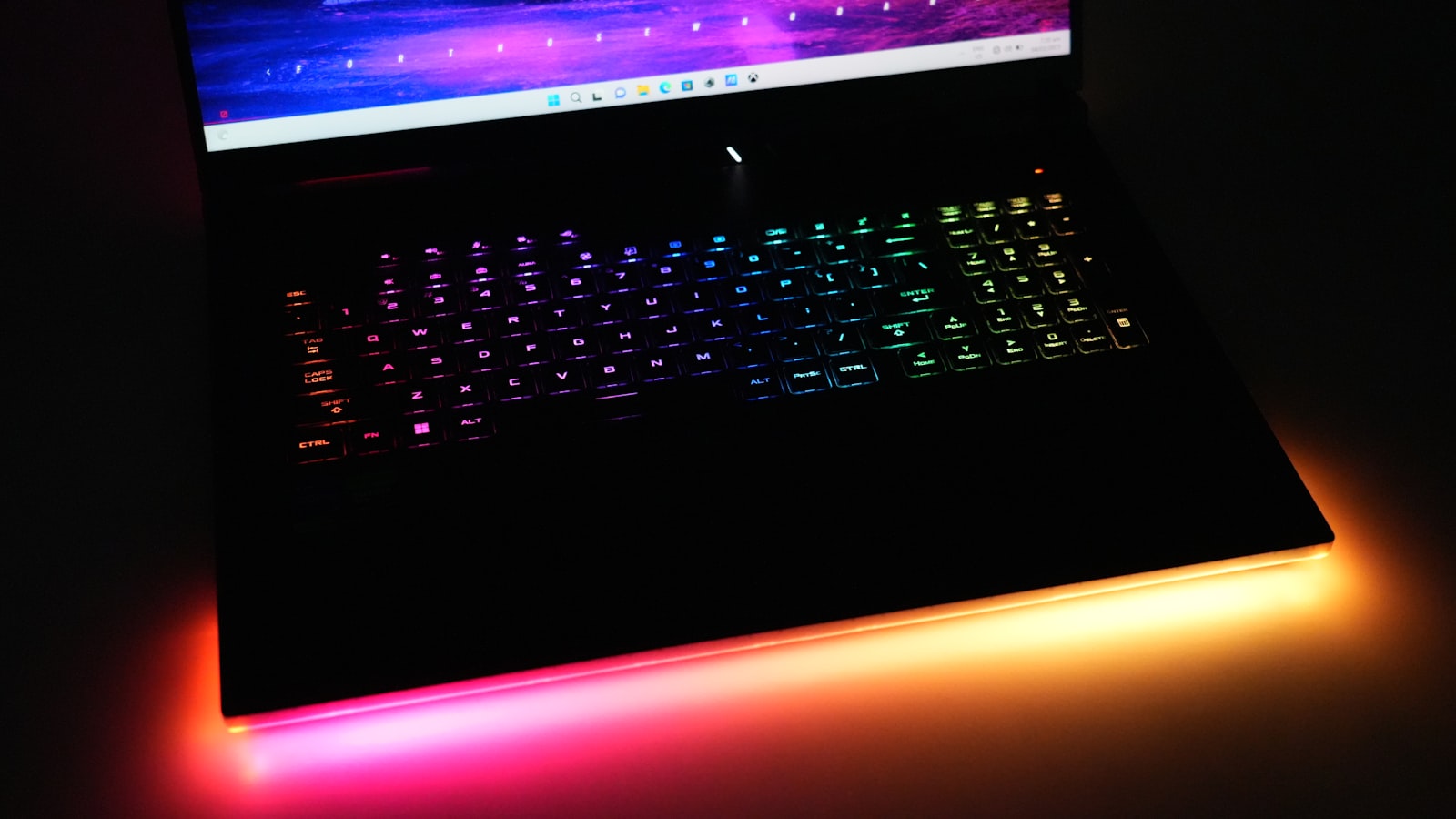 NovaBook X1 AI Studio style laptop with RGB keyboard on a dark desk